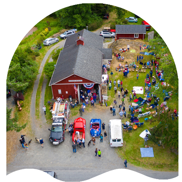 Orcas Island Weddings Videography drone photo of a fourth of july party in doe bay washington with people and cars